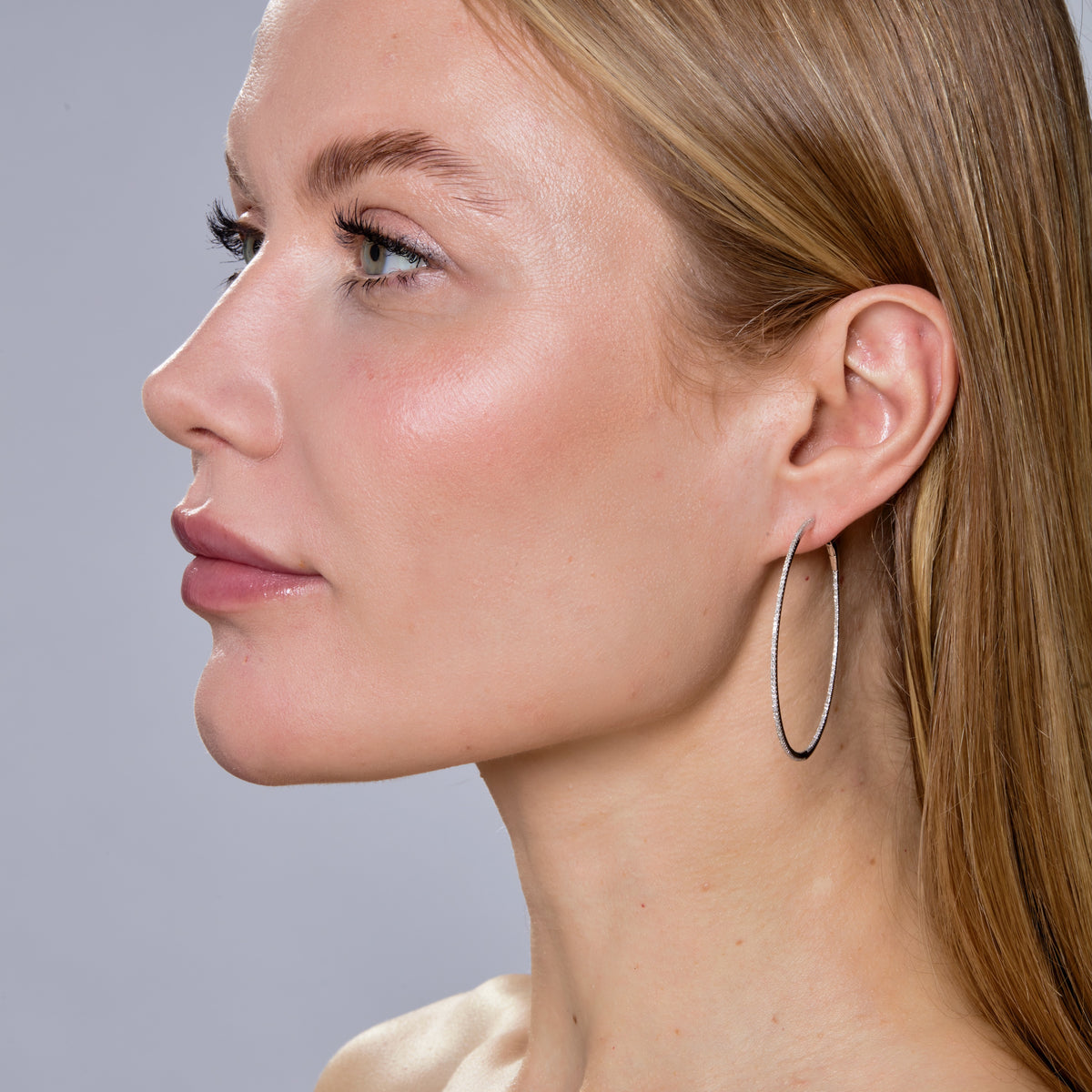 SKINNY DIAMOND HOOPS - XXL-Hoops-These extra large hoops feature a skinny row of pave diamonds on the outside as well as the inside of the hoop making it an elevated accessory for the ear. - available in 14k yellow, white, rose and black gold - diamonds: approximately 0.80 total carat weight; G-H color, SI clarity - 2" in diameter - shown on model in white gold, rose gold and black gold - sold as a pair-Anneaux Jewelry