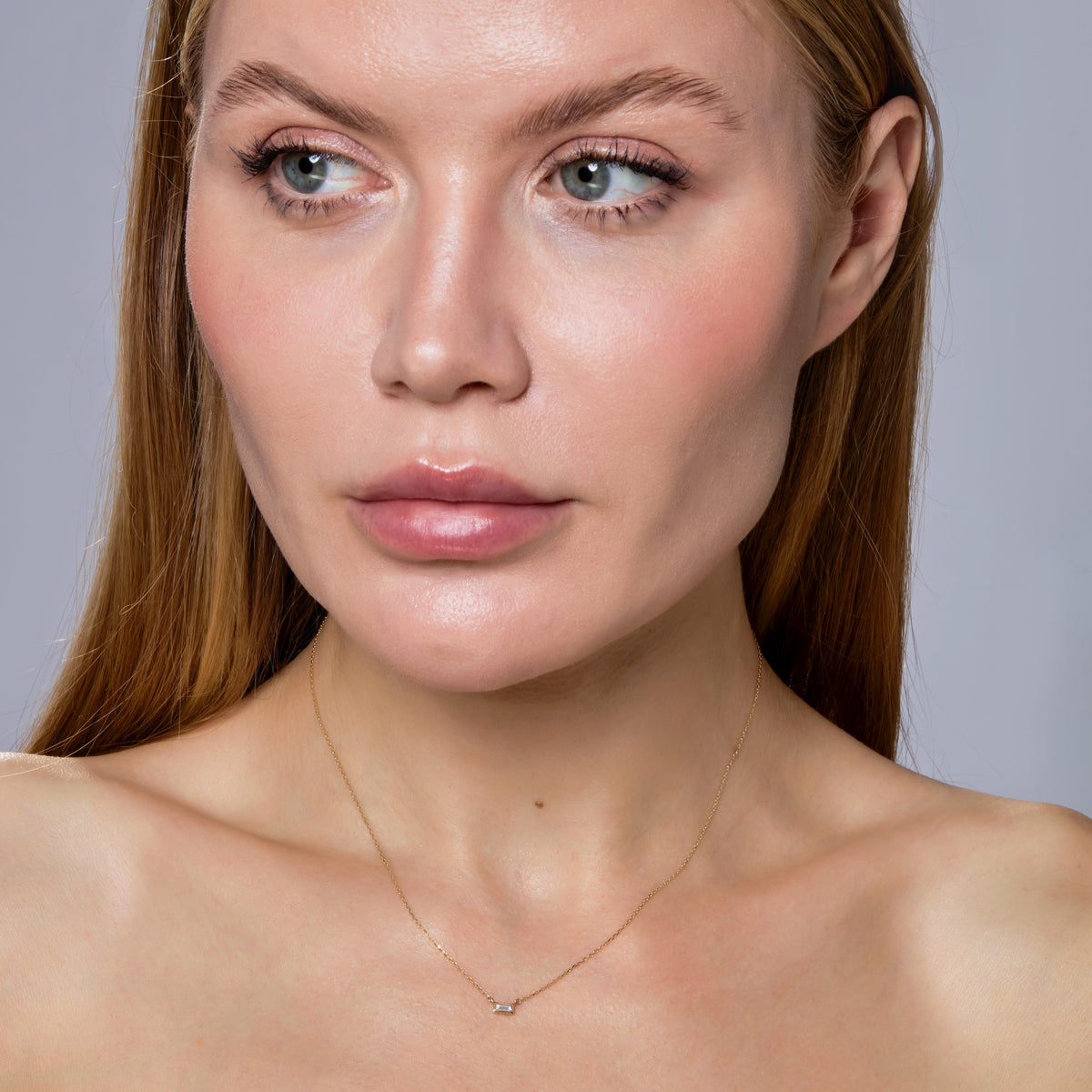 BAGUETTE DIAMOND BEZEL NECKLACE-Necklaces-A single baguette diamond is set in a gold bezel setting on a delicate chain. - available in 14k yellow and white gold - diamond: approximately 0.10 carat total weight; G-H color, SI clarity - triple extendable chain; 14” - 15” - 16” - lobster clasp - shown on model in yellow gold - custom size diamond available: ice@anneauxjewelry.com-Anneaux Jewelry