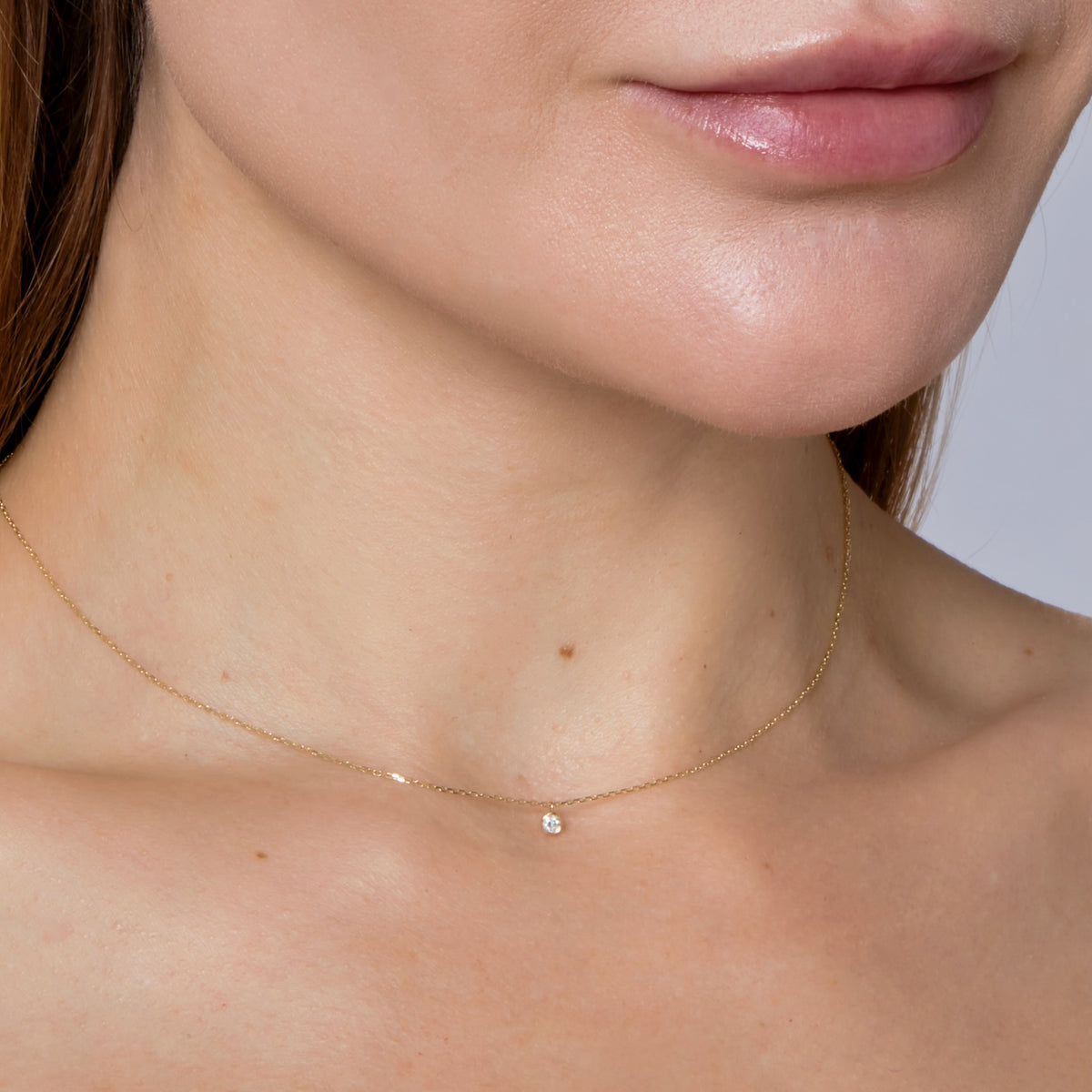 SOLITARE DIAMOND BEZEL NECKLACE-Necklaces-A simple bezel-set diamond solitaire hangs delicately from a 14k gold chain and will add the perfect dot of sparkle to your neck. Its adjustable diamond cut cable link chain makes it one of our favorite layering pieces. - available in 14k yellow, white and rose gold - diamond: approximately 0.05 total carat weight; G-H color, SI 1-2 clarity - 2.3 mm size bezel - triple extendable chain: 14” - 15” - 16” - lobster clasp - shown on model in yellow gold - cu