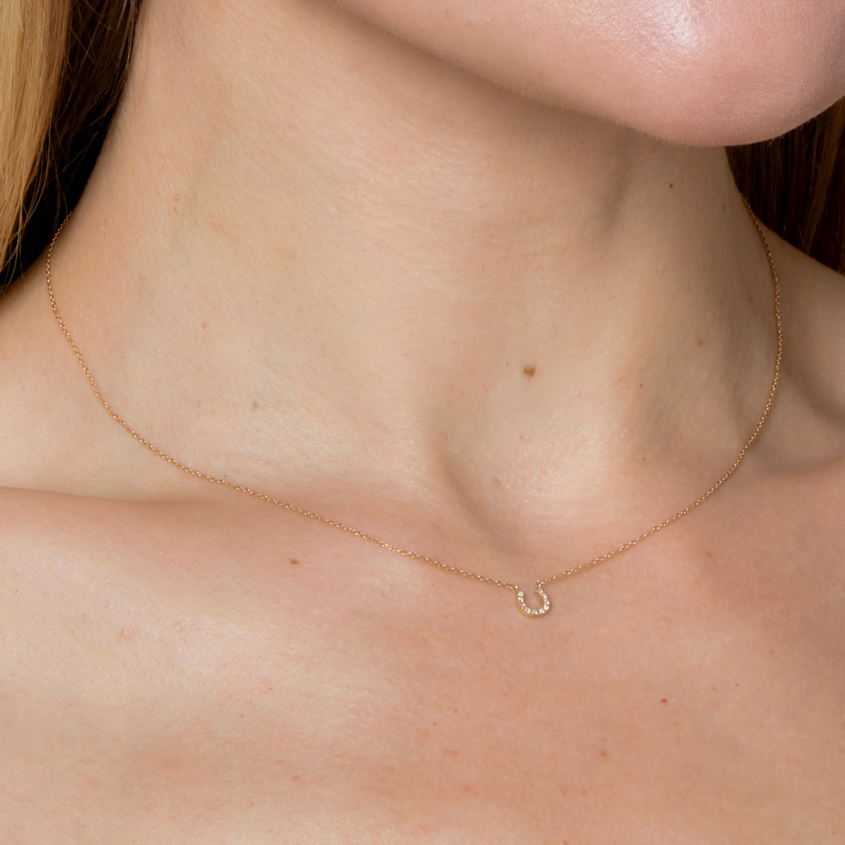 DIAMOND PAVE HORSESHOE NECKLACE-Necklaces-A diamond pave horseshoe in 14k gold hangs delicately from a diamond cut cable link chain. - available in 14k yellow and white gold - diamonds: approximately 0.03 total carat weight, G-H color, SI clarity - triple extendable chain; 14” - 15” - 16” length - spring ring clasp - shown on model in yellow gold-Anneaux Jewelry
