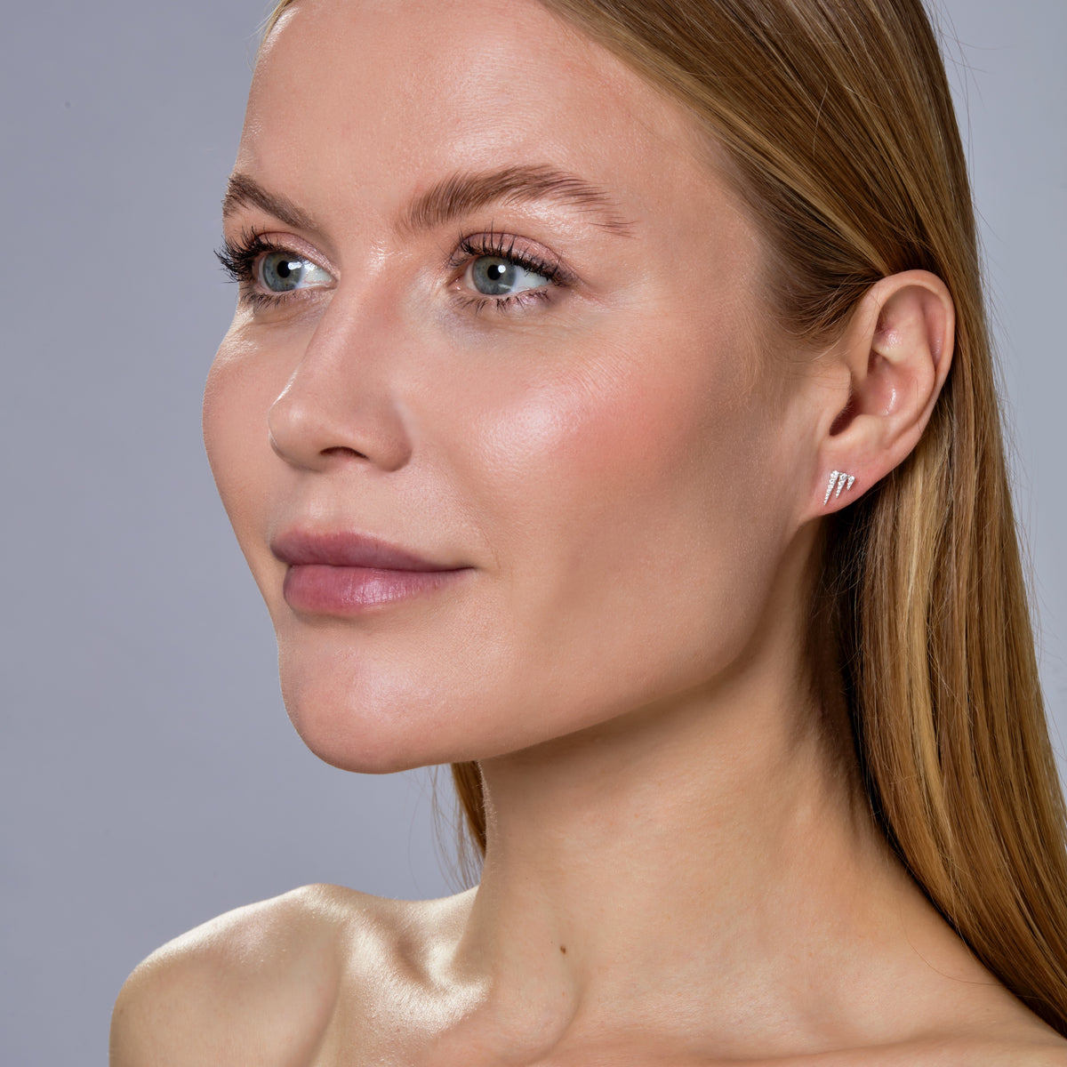 DIAMOND ICICLE STUD-Studs-Ice up your ears with three tapered triangles of cascading diamonds set in 18k white gold. - diamonds in a single stud: approximately 0.10 total carat weight; G-H color, SI clarity - 18k butterfly backing - shown on model in white gold - additional gold colors available: ice@anneauxjewelry.com-Anneaux Jewelry