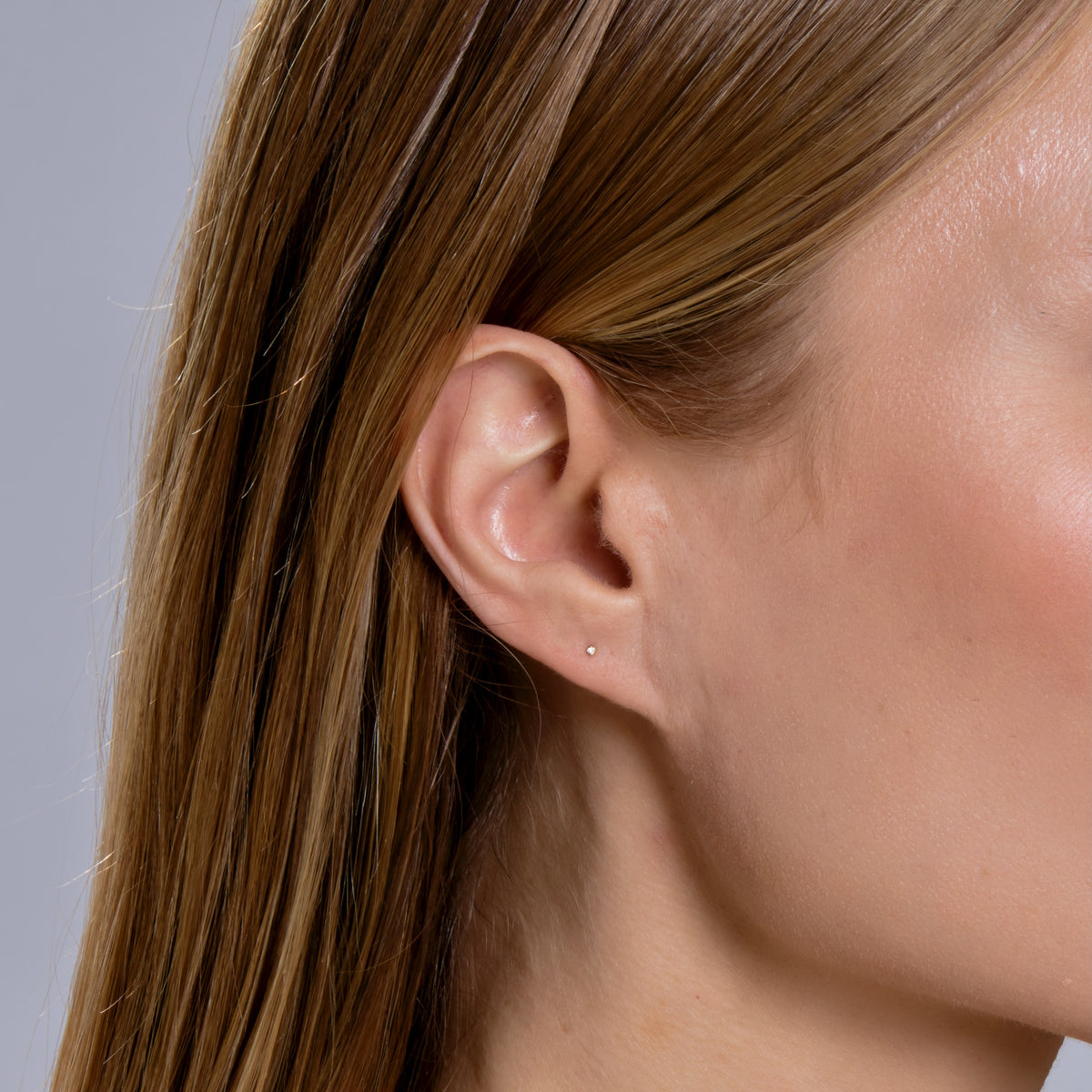 DIAMOND KISS STUD-Studs-A sweet diamond kiss for your ear set in 18k solid gold. - available in 18k yellow and white gold - diamond in single stud: approximately 0.005 total carat weight; G-H color, SI 1-2 clarity - comfort fit silicone backing - shown on model in yellow gold-Anneaux Jewelry